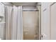 Shower and bathtub with curtain and glass enclosure, next to the white door at 4808 Sunview Ct, Suwanee, GA 30024