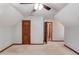 Unique bedroom with light carpet, wood trim, and doorway to a walk-in closet at 4808 Sunview Ct, Suwanee, GA 30024