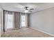 Cozy bedroom features plush carpeting, modern ceiling fan, and light gray walls at 4808 Sunview Ct, Suwanee, GA 30024