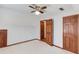 Unique bedroom with light carpet, wood trim, and doorway to a walk-in closet at 4808 Sunview Ct, Suwanee, GA 30024