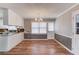 Bright dining area and galley kitchen with white cabinets, stainless steel appliances, and granite countertops at 4808 Sunview Ct, Suwanee, GA 30024