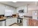 Charming kitchen with white cabinets, stainless steel appliances, and granite countertops at 4808 Sunview Ct, Suwanee, GA 30024