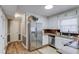 Updated kitchen featuring stainless steel appliances, white cabinets, and tile backsplash at 4808 Sunview Ct, Suwanee, GA 30024