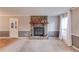 Cozy living room with a stone fireplace, neutral carpet, and a large window with natural light at 4808 Sunview Ct, Suwanee, GA 30024