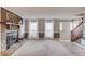 Inviting living room with stone fireplace, large windows, and staircase leading upstairs at 4808 Sunview Ct, Suwanee, GA 30024