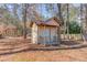 Small outbuilding in a wooded area with a small front porch and railing at 4808 Sunview Ct, Suwanee, GA 30024