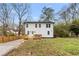 Backyard view of home with wood deck, fenced yard, and well-maintained lawn at 770 Waters Sw Dr, Atlanta, GA 30310