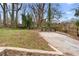 Spacious backyard featuring mature trees and drive-up parking pad at 770 Waters Sw Dr, Atlanta, GA 30310