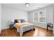 Inviting bedroom with warm wood floors, a metal bed frame, and natural light from the windows at 770 Waters Sw Dr, Atlanta, GA 30310