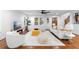 Bright living room featuring white furniture, area rug, hardwood floors, and natural light at 770 Waters Sw Dr, Atlanta, GA 30310