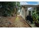 Side view of the backyard showcasing the natural landscape and exterior of the home at 832 Chalet Hls, Mcdonough, GA 30253