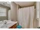 Cozy bathroom featuring a shower with a white curtain and a vanity with a mirror at 832 Chalet Hls, Mcdonough, GA 30253