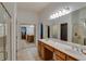 En suite bathroom with double sinks, a large mirror, vanity and a glass shower door at 832 Chalet Hls, Mcdonough, GA 30253