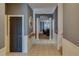 Elegant hallway with tiled floor, decorative columns and wainscotting leads into the living spaces at 832 Chalet Hls, Mcdonough, GA 30253