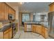 Galley kitchen featuring stainless steel appliances, granite countertops, and wooden cabinets for ample storage at 832 Chalet Hls, Mcdonough, GA 30253