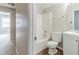 Clean bathroom with a tub and shower combo, white vanity, and wood look flooring at 1070 Thornwood Cir, Covington, GA 30016
