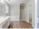 Bathroom featuring double sink vanity, bathtub, and a glass-door shower at 1070 Thornwood Cir, Covington, GA 30016