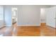 Bedroom featuring wood floors and doorways to an en suite bathroom and hallway at 1070 Thornwood Cir, Covington, GA 30016