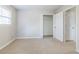 Bright bedroom with neutral walls, carpet, window, and closet with double doors at 1070 Thornwood Cir, Covington, GA 30016