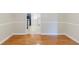 View of the dining room showcasing wood floors and an opening to the kitchen at 1070 Thornwood Cir, Covington, GA 30016
