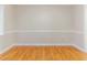 Dining area features warm wood floors, neutral walls, and elegant trim detail at 1070 Thornwood Cir, Covington, GA 30016