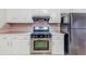 Modern kitchen with a stainless steel oven, white cabinets, and ample countertop space at 1070 Thornwood Cir, Covington, GA 30016