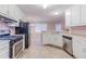 Well-lit kitchen featuring stainless steel appliances and white cabinetry at 1070 Thornwood Cir, Covington, GA 30016
