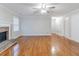 Spacious living room with hardwood floors, fireplace, ceiling fan and plenty of natural light at 1070 Thornwood Cir, Covington, GA 30016