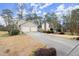 Long driveway leading to a two-car garage on a traditionally styled home at 1745 Pierce Arrow Pkwy, Tucker, GA 30084