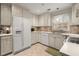 Charming kitchen featuring white appliances, tile backsplash, ample cabinet space and eat in dining area at 1745 Pierce Arrow Pkwy, Tucker, GA 30084