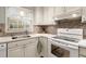 Well-lit kitchen with white cabinets, stainless steel sink, and modern appliances at 1745 Pierce Arrow Pkwy, Tucker, GA 30084