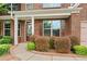 Inviting front entrance adorned with lush bushes and brick facade at 4590 Wollaston Road, Cumming, GA 30041