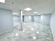 Finished basement area featuring sleek gray floors, perfect for creating additional living space at 6553 Meadowbrook Ln, Morrow, GA 30260