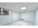 Finished basement with a small window and durable gray flooring, ready for customization at 6553 Meadowbrook Ln, Morrow, GA 30260