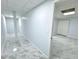 Finished basement hallway featuring gray floors leading to more rooms, expanding the living area of the home at 6553 Meadowbrook Ln, Morrow, GA 30260