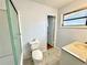 A bathroom with a shower, toilet, granite topped vanity and updated flooring at 6553 Meadowbrook Ln, Morrow, GA 30260