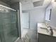Basement bathroom with a glass-enclosed shower, marble floors, and a modern vanity at 6553 Meadowbrook Ln, Morrow, GA 30260