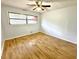 Bedroom featuring wood floors, a ceiling fan, and a window that offers natural light at 6553 Meadowbrook Ln, Morrow, GA 30260