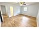 Bedroom with hardwood floors, ceiling fan, and natural light from the window at 6553 Meadowbrook Ln, Morrow, GA 30260