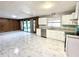 Open-concept kitchen with white cabinets, stainless steel appliances, and marble floors at 6553 Meadowbrook Ln, Morrow, GA 30260