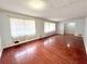 Spacious living room featuring wood floors, light gray walls and a large windows allowing for plenty of natural light at 6553 Meadowbrook Ln, Morrow, GA 30260