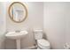 Simple half-bathroom with pedestal sink and toilet at 10950 Glenhurst Pass, Duluth, GA 30097