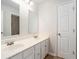 Bright bathroom featuring double sinks, a vanity with white cabinets, and modern fixtures at 10950 Glenhurst Pass, Duluth, GA 30097