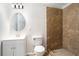 Modern bathroom with beautiful tiled walk-in shower and stylish vanity with oval mirror at 10950 Glenhurst Pass, Duluth, GA 30097