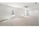 Large bedroom featuring neutral carpet, a ceiling fan, and large windows for natural light at 10950 Glenhurst Pass, Duluth, GA 30097