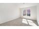 Comfortable bedroom with neutral carpet, white walls, and a bright window providing natural light at 10950 Glenhurst Pass, Duluth, GA 30097