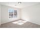 Minimalist bedroom with neutral carpet, a large window, and plenty of natural light at 10950 Glenhurst Pass, Duluth, GA 30097