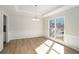 Elegant dining room with a modern chandelier, wainscoting, and large window at 10950 Glenhurst Pass, Duluth, GA 30097