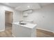Bright kitchen featuring an island with stainless steel sink and modern white cabinetry at 10950 Glenhurst Pass, Duluth, GA 30097