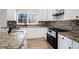 Updated kitchen with white cabinets, granite countertops, stainless steel appliances, and ample counter space at 10950 Glenhurst Pass, Duluth, GA 30097